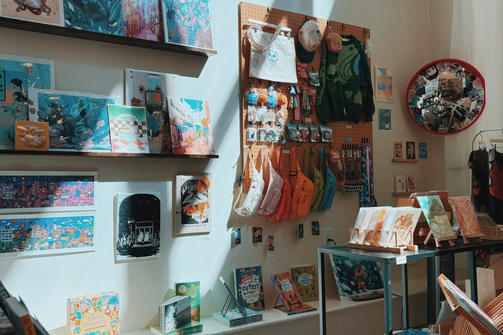 Store interior with shelves displaying various items and a wall with more products.